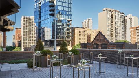 outdoor rooftop venue set with high square tables