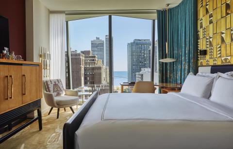 A room at Viceroy Chicago with floor to ceiling windows and a beautiful view of the city