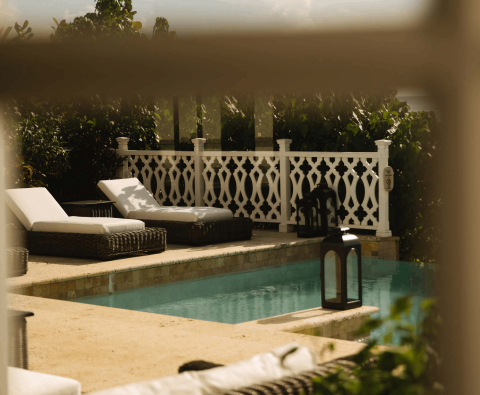 Two lounge recliners by the pool at Viceroy Sugar Beach