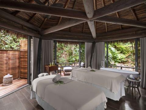 Two massage beds in a hut outside at Viceroy Sugar Beach