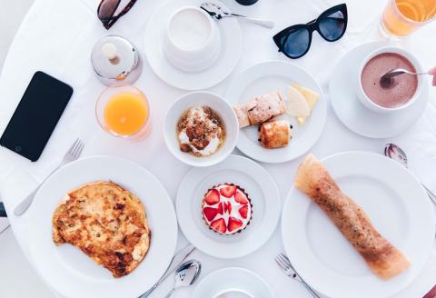 A spread of breakfast food and drinks on a table at Viceroy Zena Washington DC