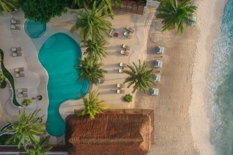 Overhead view of the beach, a pool, and accommodations at Viceroy Riviera Maya