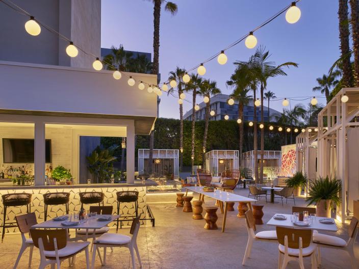 The patio at Sugar Palm, Viceroy Santa Monica, with string lights hanging overhead