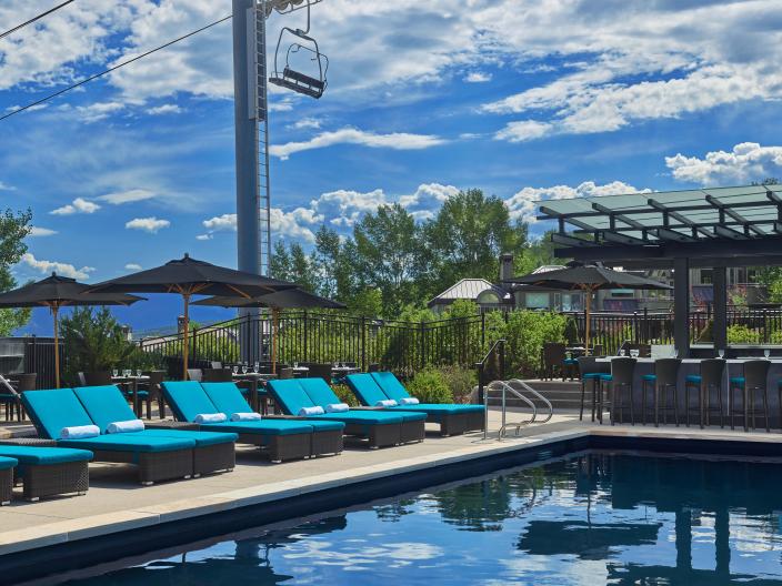 The pool and lounge area at Viceroy Snowmass on a sunny day.