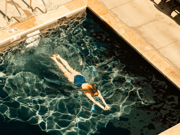 A woman swimming in a pool at Viceroy Snowmass