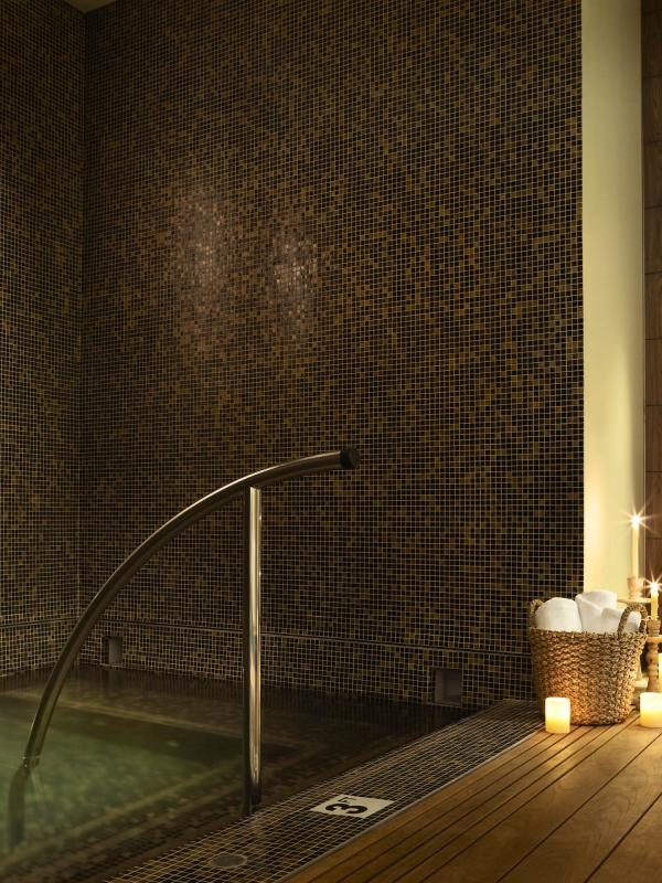 A wading pool at Viceroy Snowmass spa, lit by candles