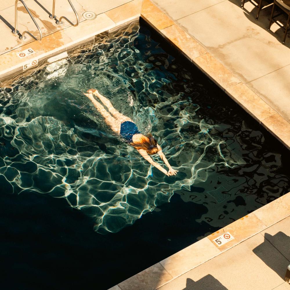 aerial view of woman swimming in pool