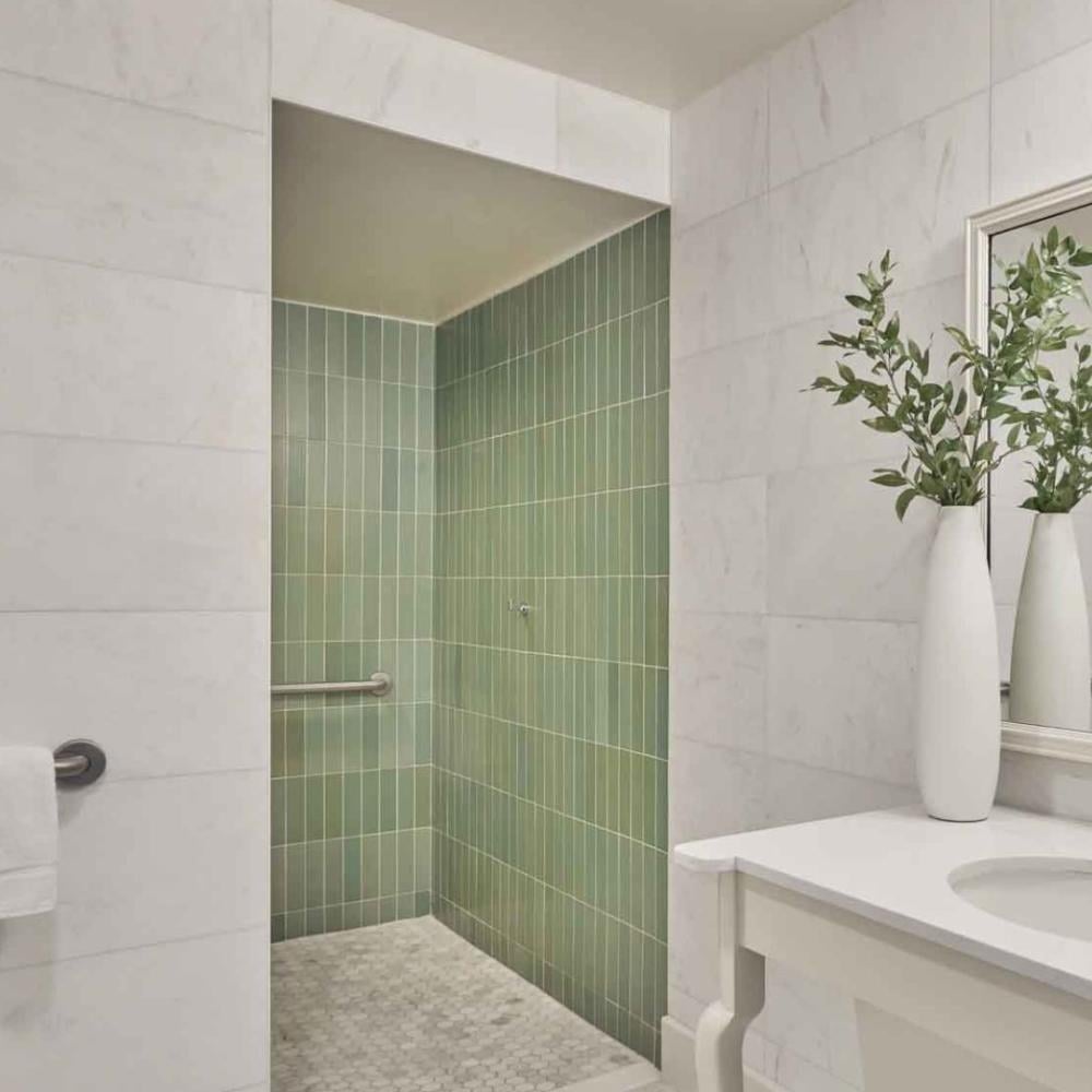 A vanity and green tiles shower in a suite at Viceroy Santa Monica