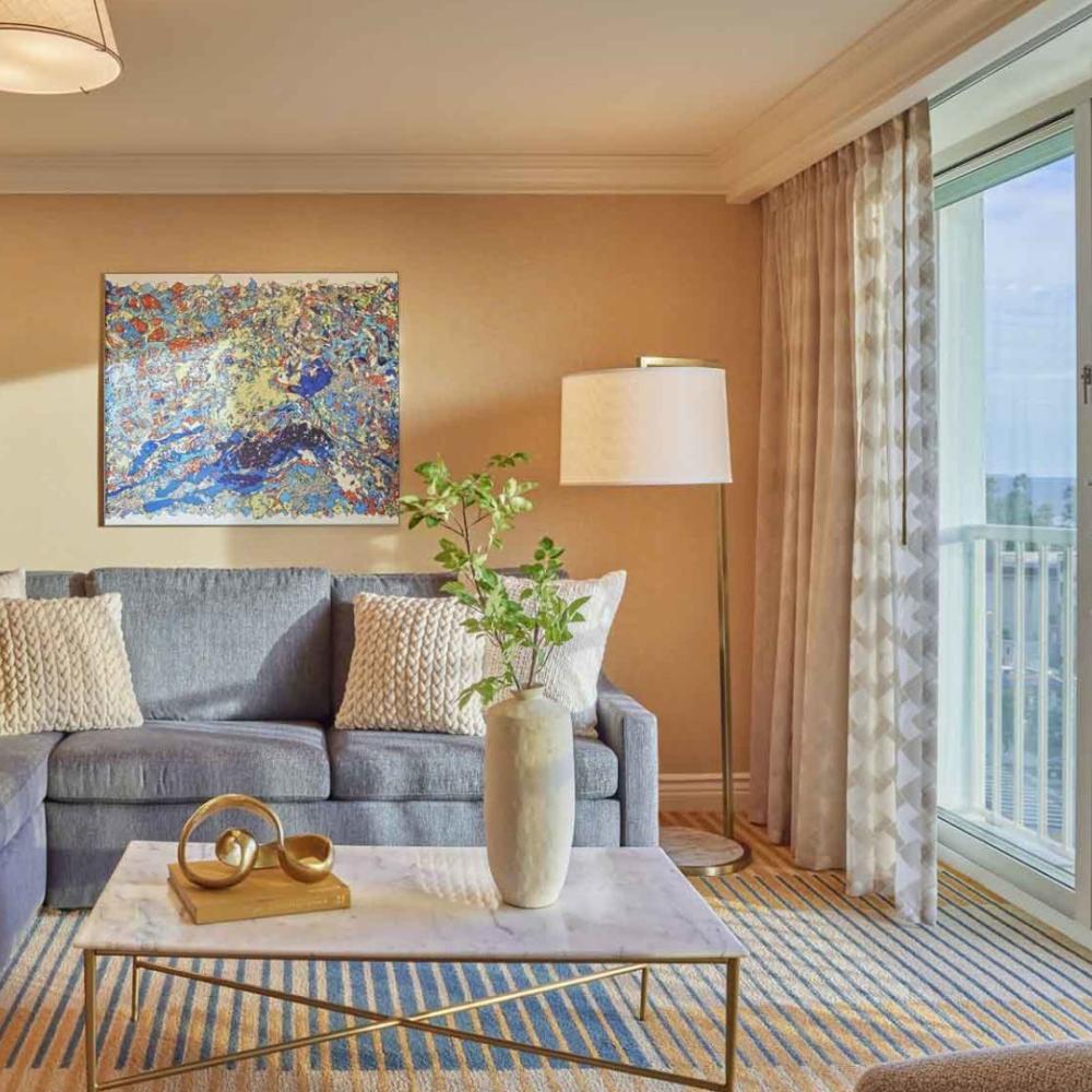 A couch and balcony  in a Junior Suite at Viceroy Santa Monica