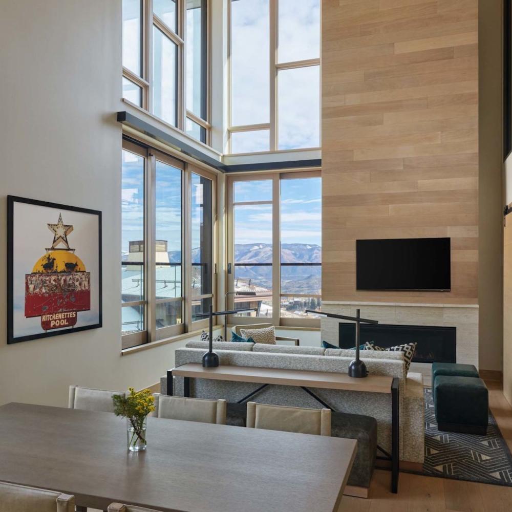 The dining space and living room in a Cirque Two Bedroom Penthouse Loft at Viceroy Snowmass