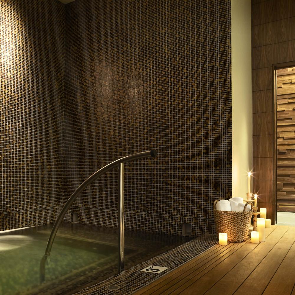 A wading pool at Viceroy Snowmass spa, lit by candles