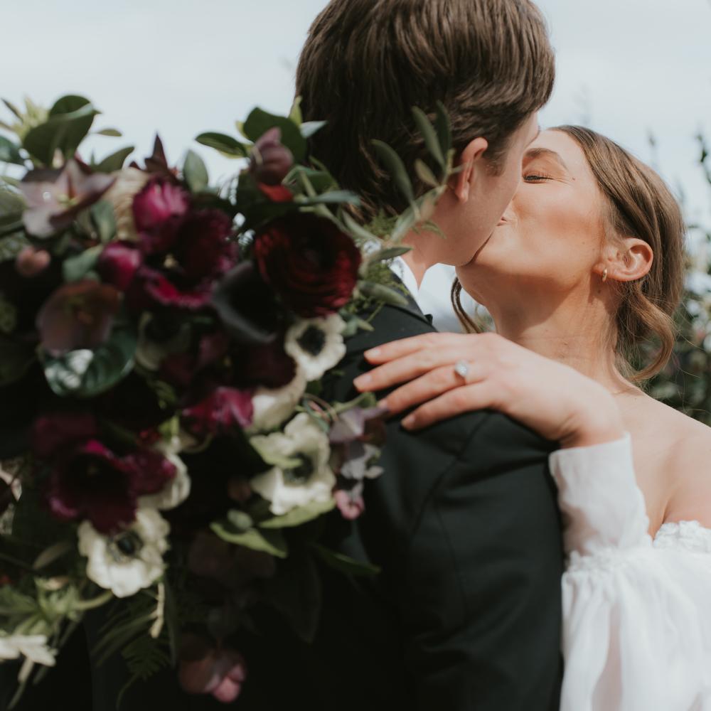 A bride and groom kissing on their wedding day