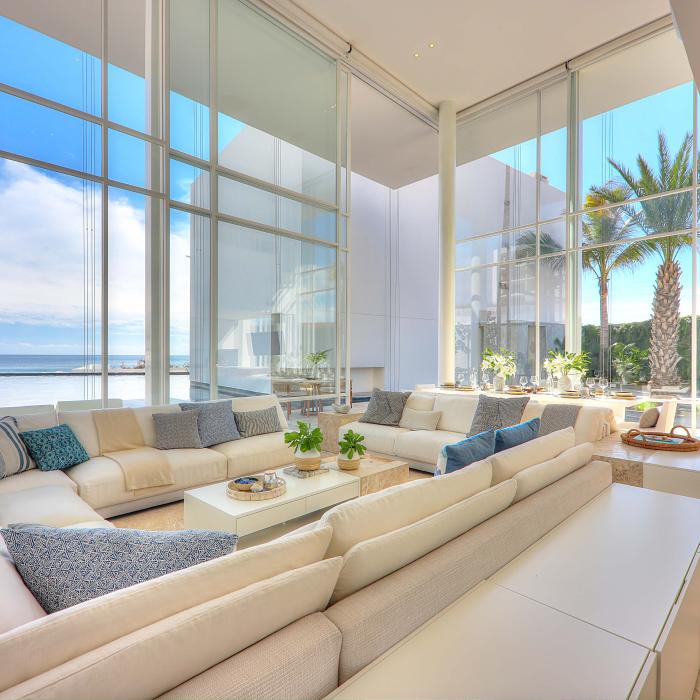 los cabos waterside villa living room area with a large sofa and floor to ceiling windows