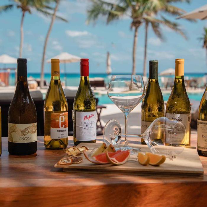 bottles of wine sit on wooden table