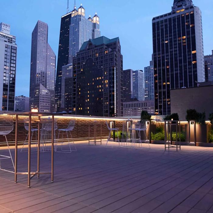 Terrace at Viceroy Chicago, with high-rise Chicago architecture surrounding it at dusk