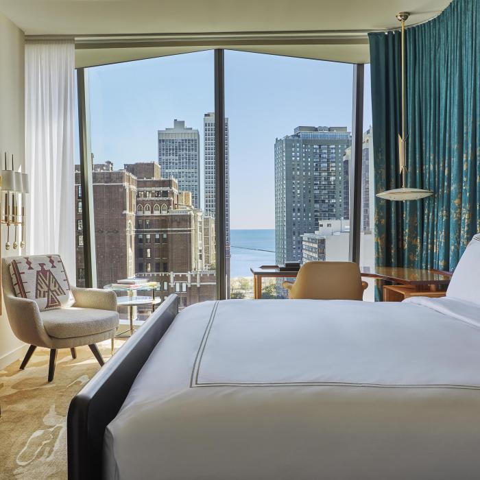 A room at Viceroy Chicago with floor to ceiling windows and a beautiful view of the city