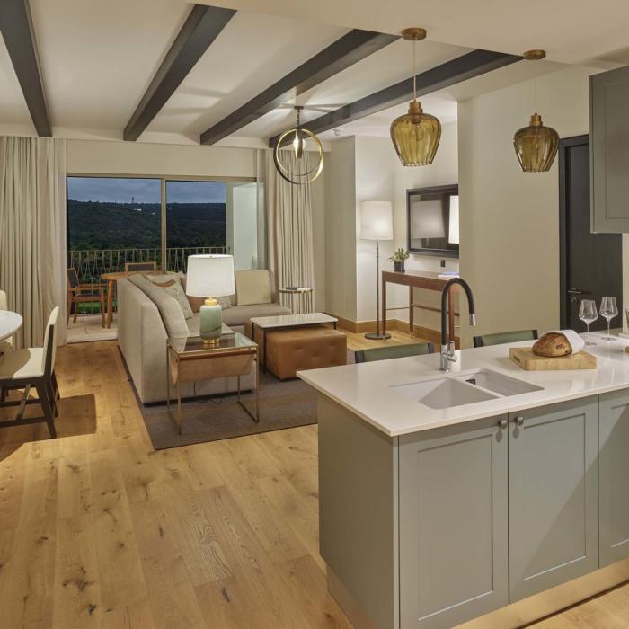 A spacious open kitchen into living room area overlooking a terrace in a residence at Viceroy Ombris Algarve