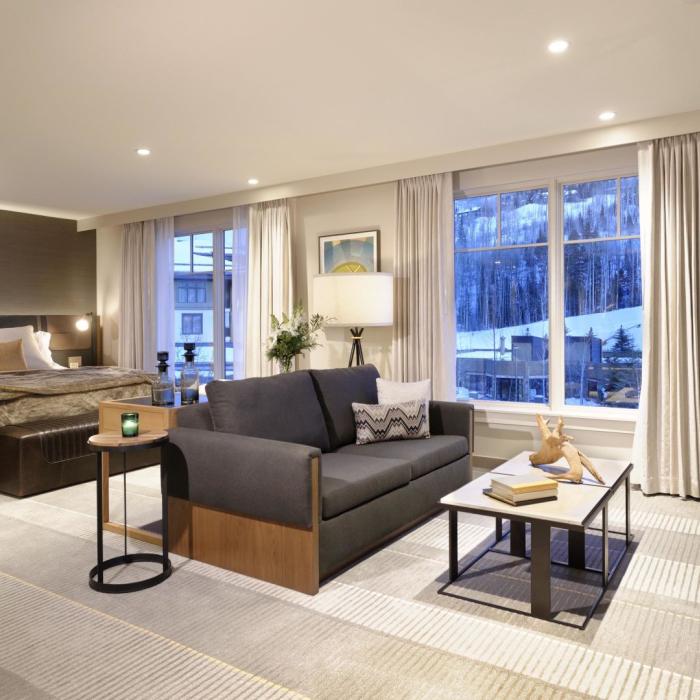 Bedroom with couch and fireplace at Viceroy Snowmass