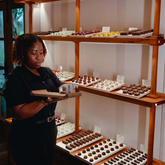 A worker puts chocolates on display at Cocoa Mill