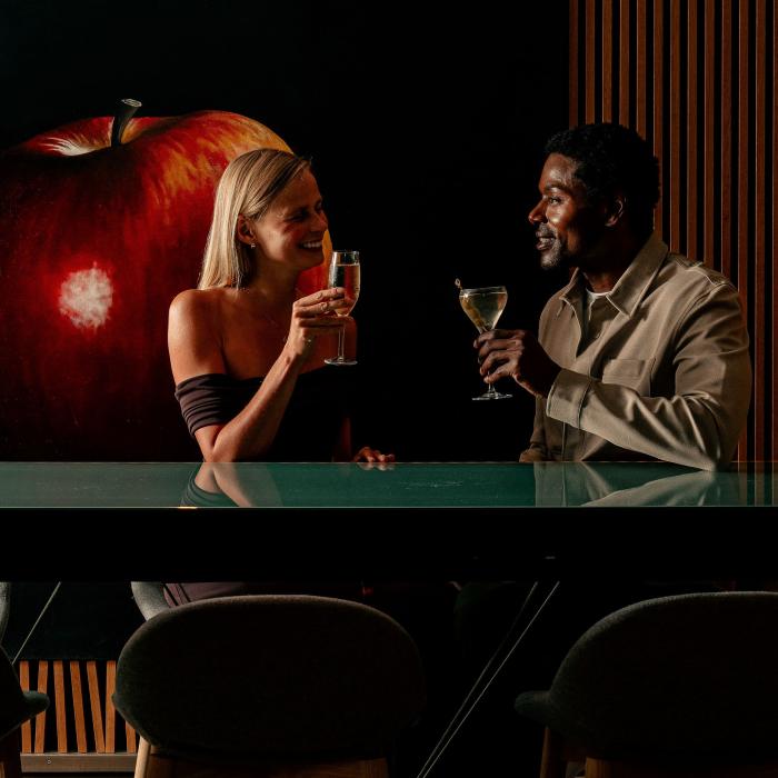 A couple toasting together in the chic Zena lounge.