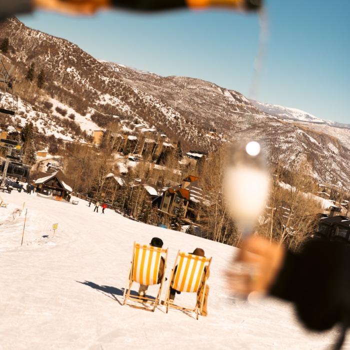 Champagne is being poured at the top of the ski slope.