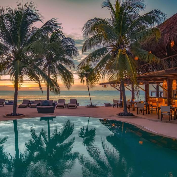 The tranquil beaches and pools of Viceroy Riviera Maya at sunset