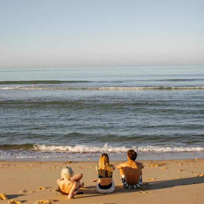 Three friends on the beach in Algarve Portugal