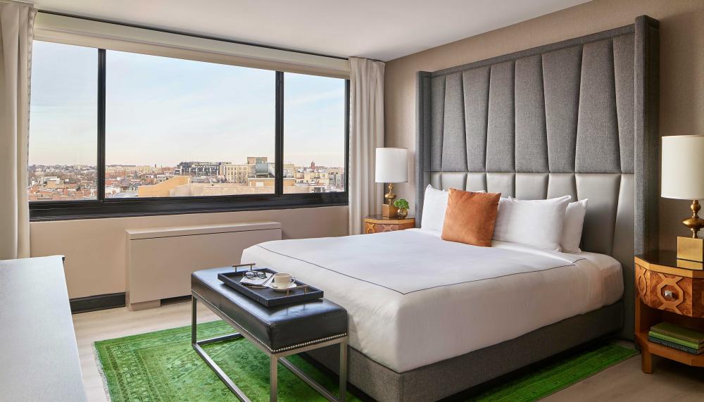 bedroom with king bed and a green rug