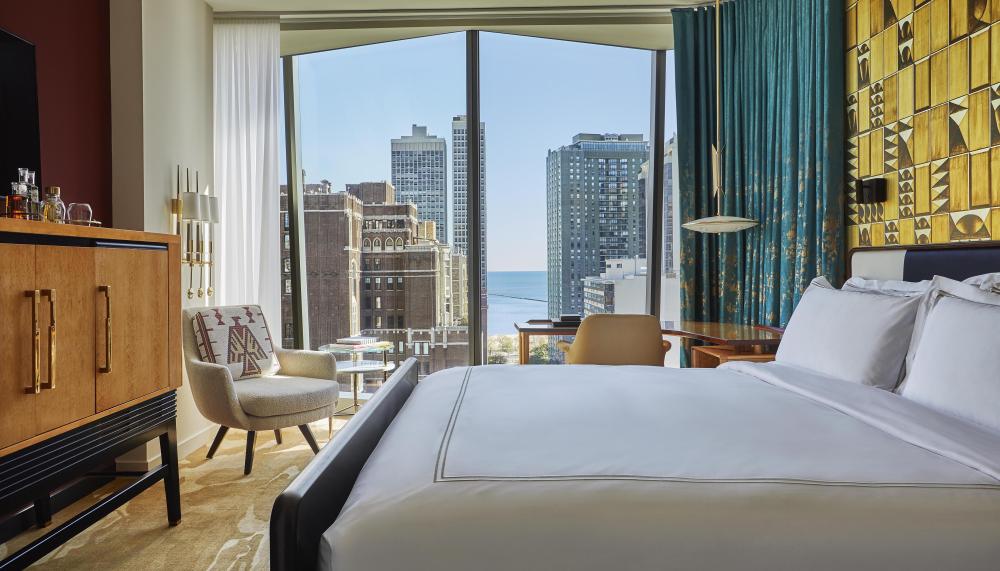 A room at Viceroy Chicago with floor to ceiling windows and a beautiful view of the city