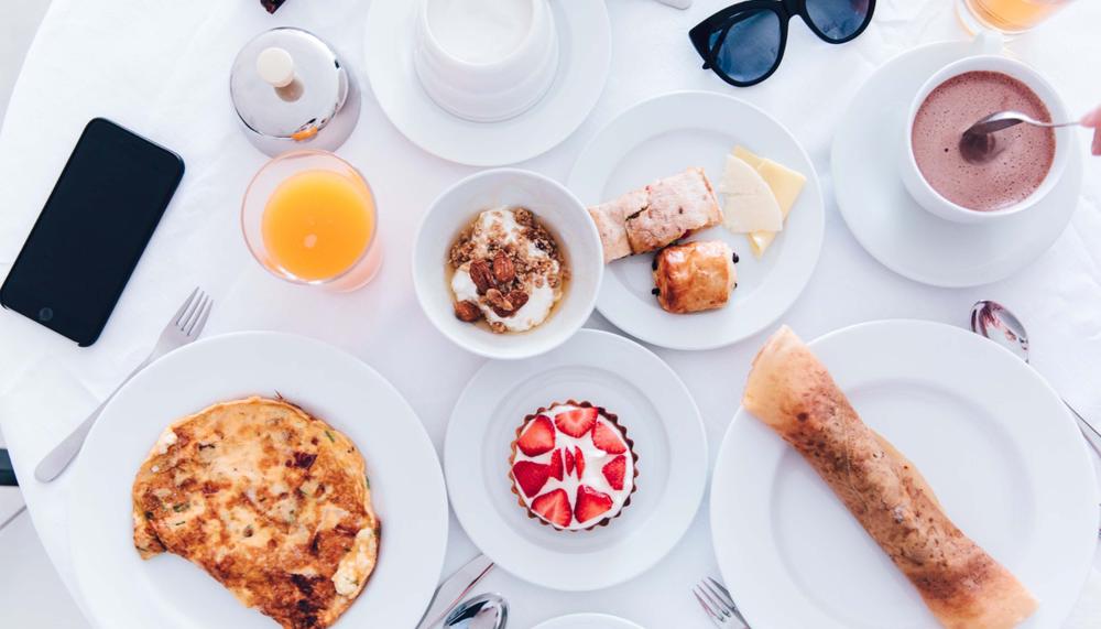 A spread of breakfast food and drinks on a table at Viceroy Zena Washington DC