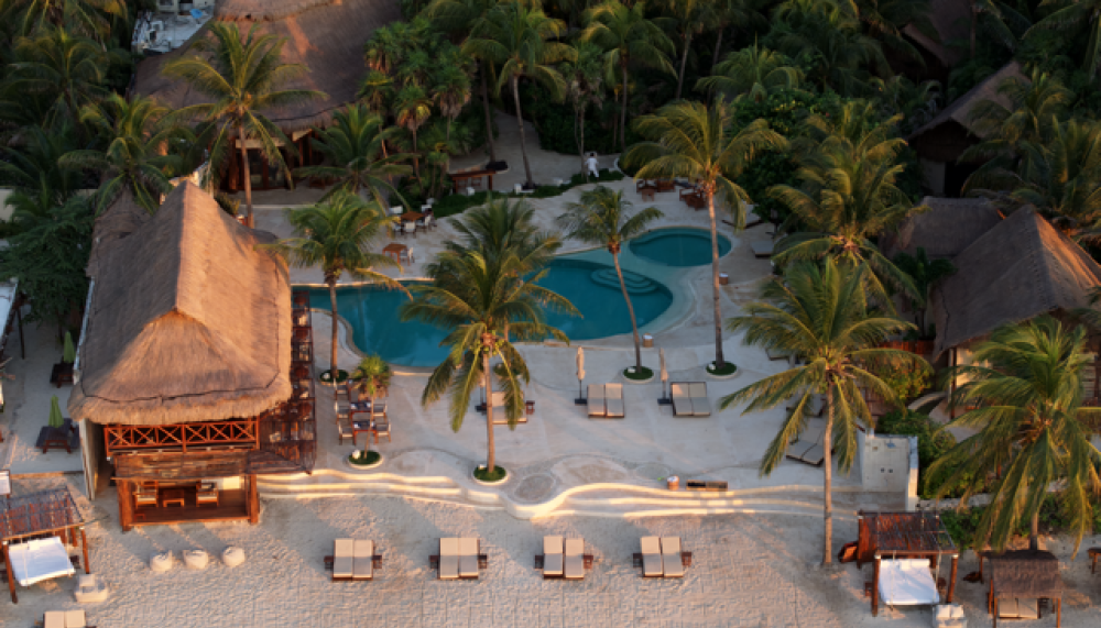 An aerial view of the beach and pool that surround the Viceroy Riviera Maya.