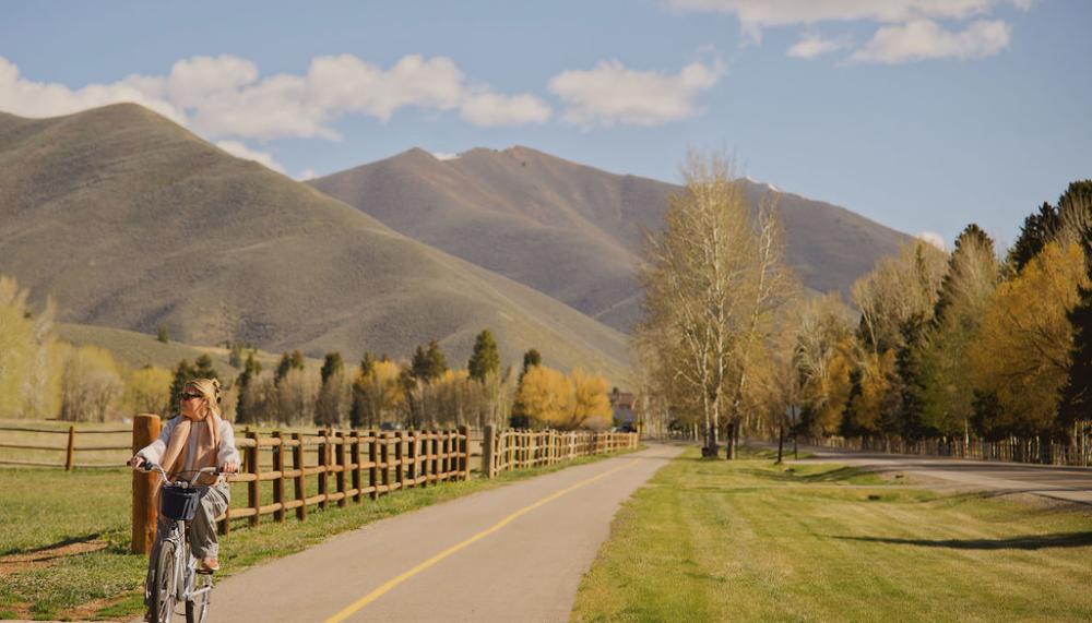 woman riding bike through sun valley