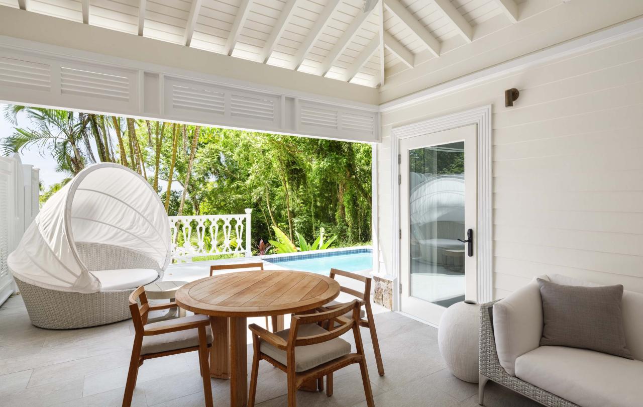 covered patio with dining table and sofa