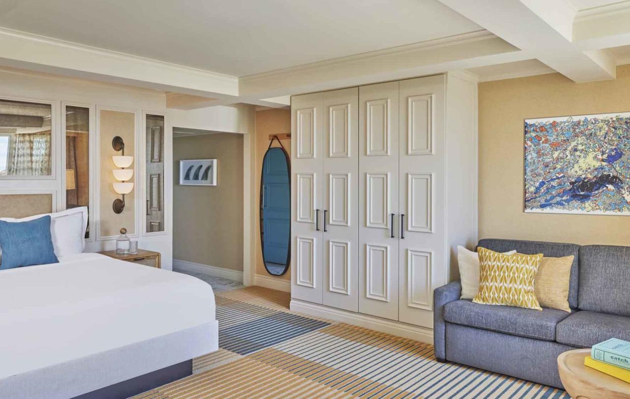 A king bed and a couch in a suite at Viceroy Santa Monica