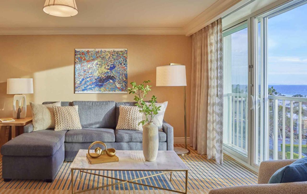 A couch and balcony  in a Junior Suite at Viceroy Santa Monica