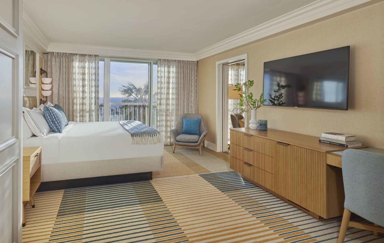 King bed room interior with large TV mounted to wall