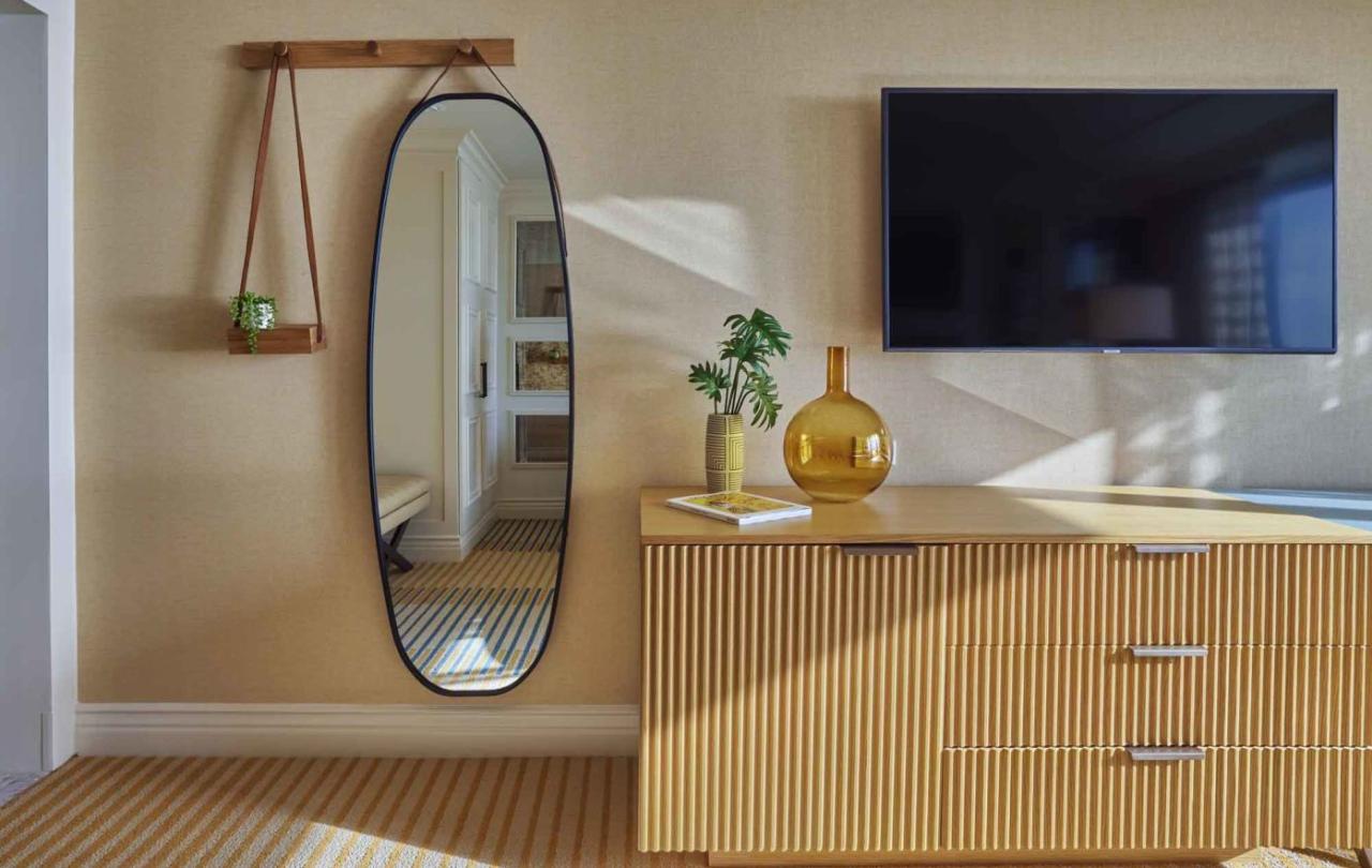 Room interior with mounted TV and wicker TV console
