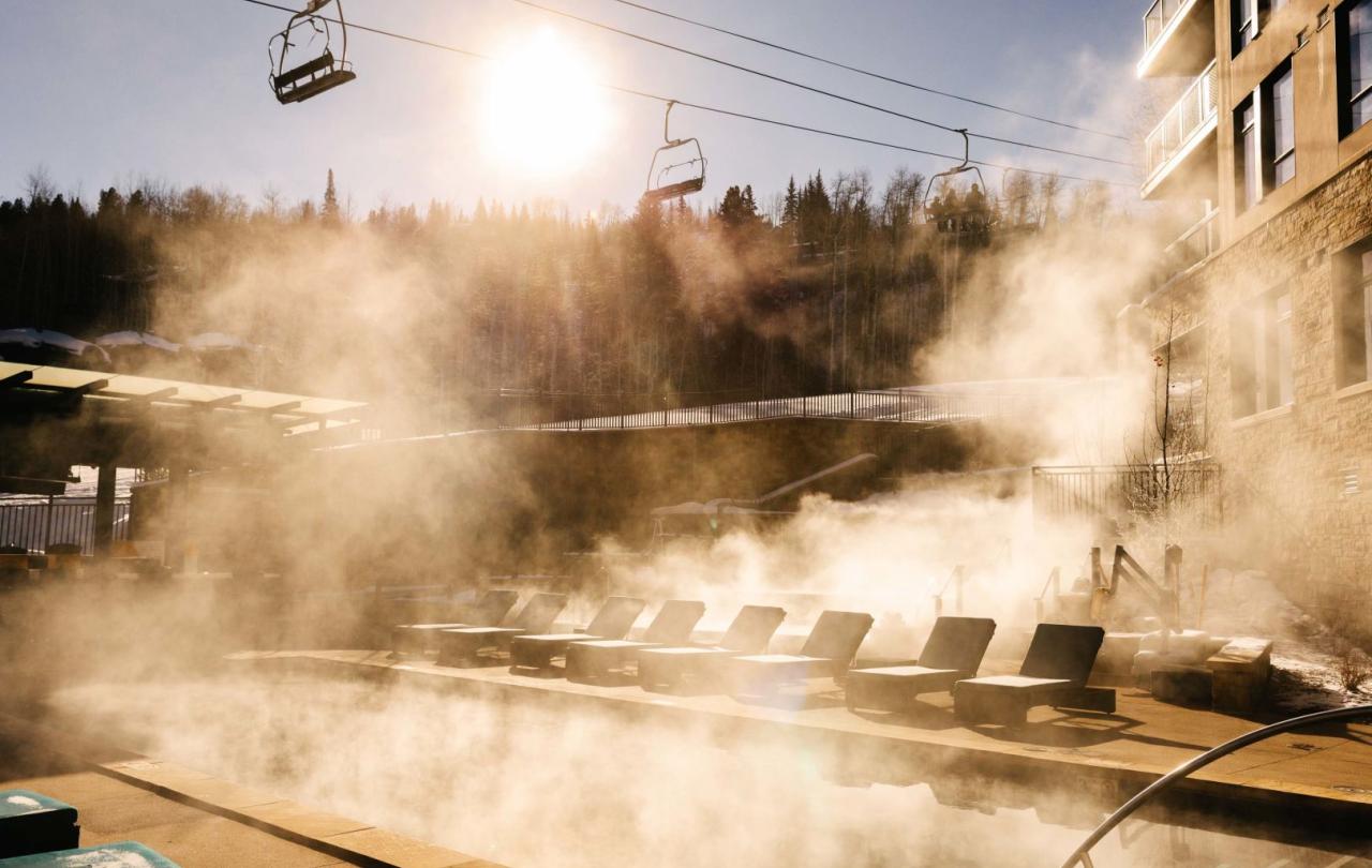 Viceroy Snowmass exterior heated pools with gondolas passing overtop