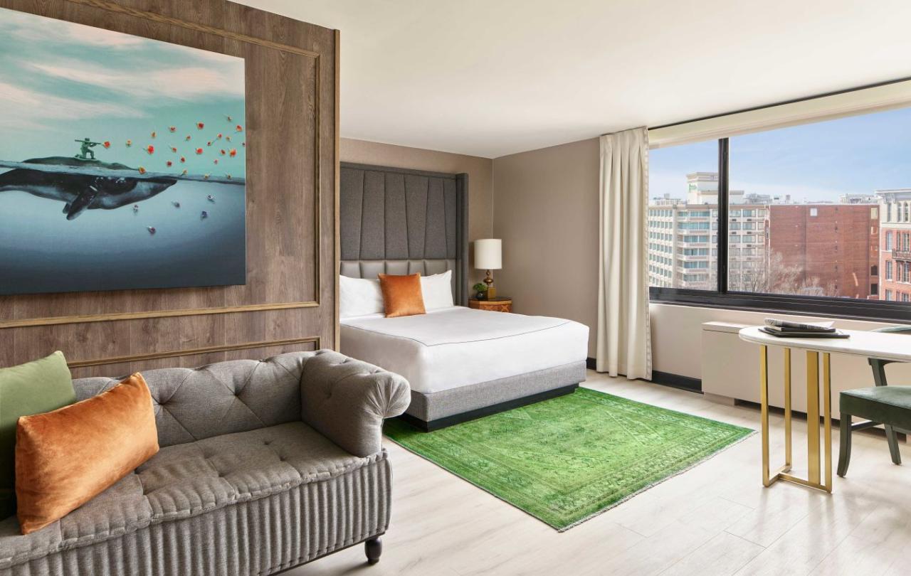A living room area and bedroom in a Viceroy Washington DC room