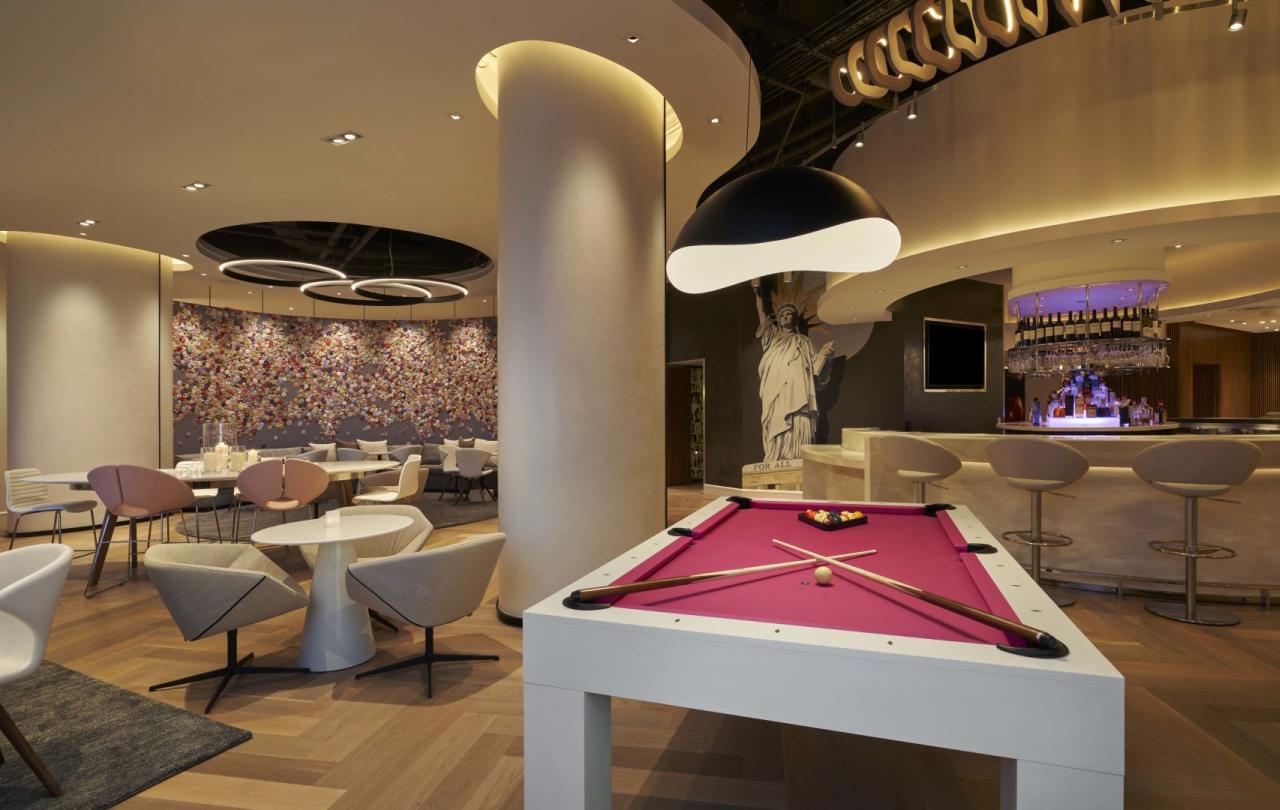 A venue with a pool table, bar, and eating area at Viceroy Zena DC