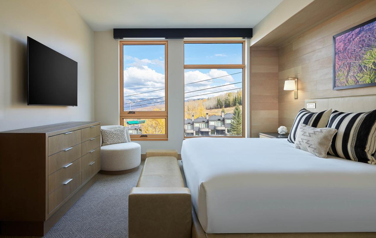 interior of bedroom with tv and exterior views