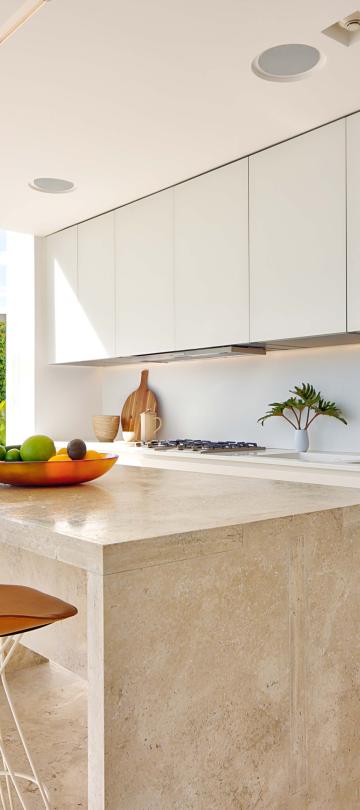 los cabos waterside villa's full kitchen with an island paired with barstools