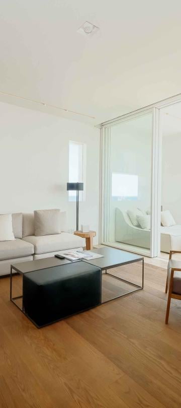 los cabos ocean view living room with couch, coffee table and chair