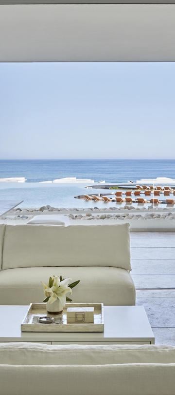living room area with views of balcony in Los Cabos suite