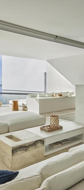 interior view of living room with balcony and ocean in background