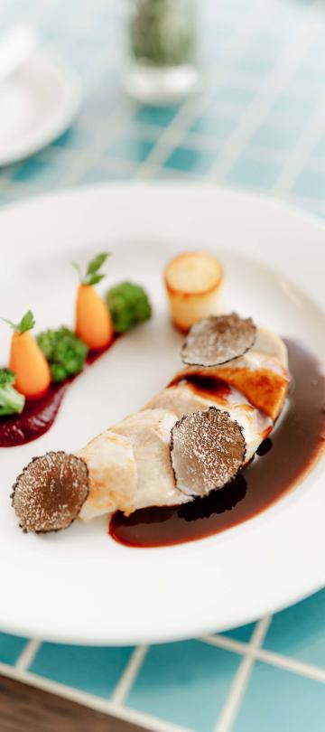 vegetables and meat plated on a blue checkered table
