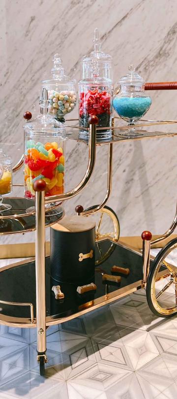 A cart with jars of candy on it