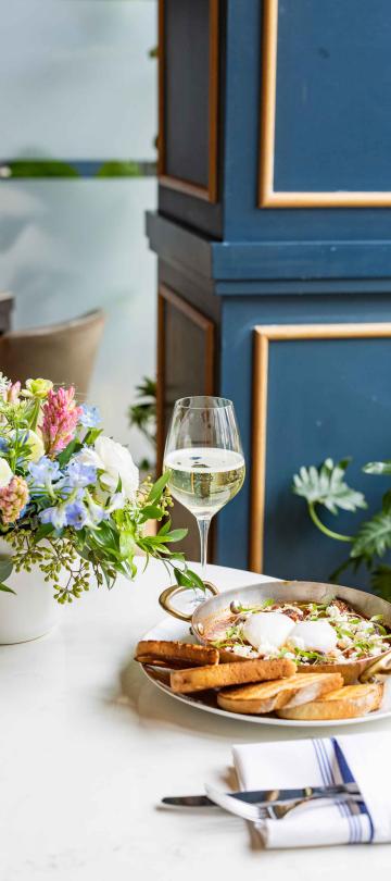 Table of food with flowers and wine