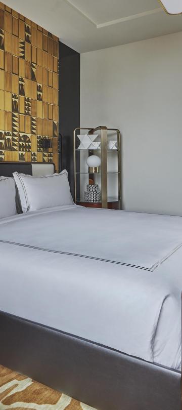 Bedroom with queen bed and desk area