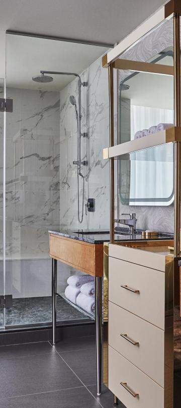 Bathroom with two vanities and a shelving unit